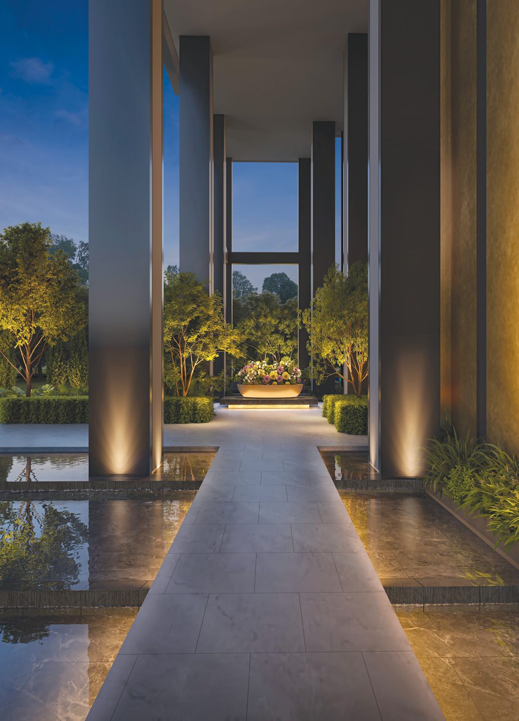 Hudson Place Residences grand entrance corridor at night with flanking water features and uplighting